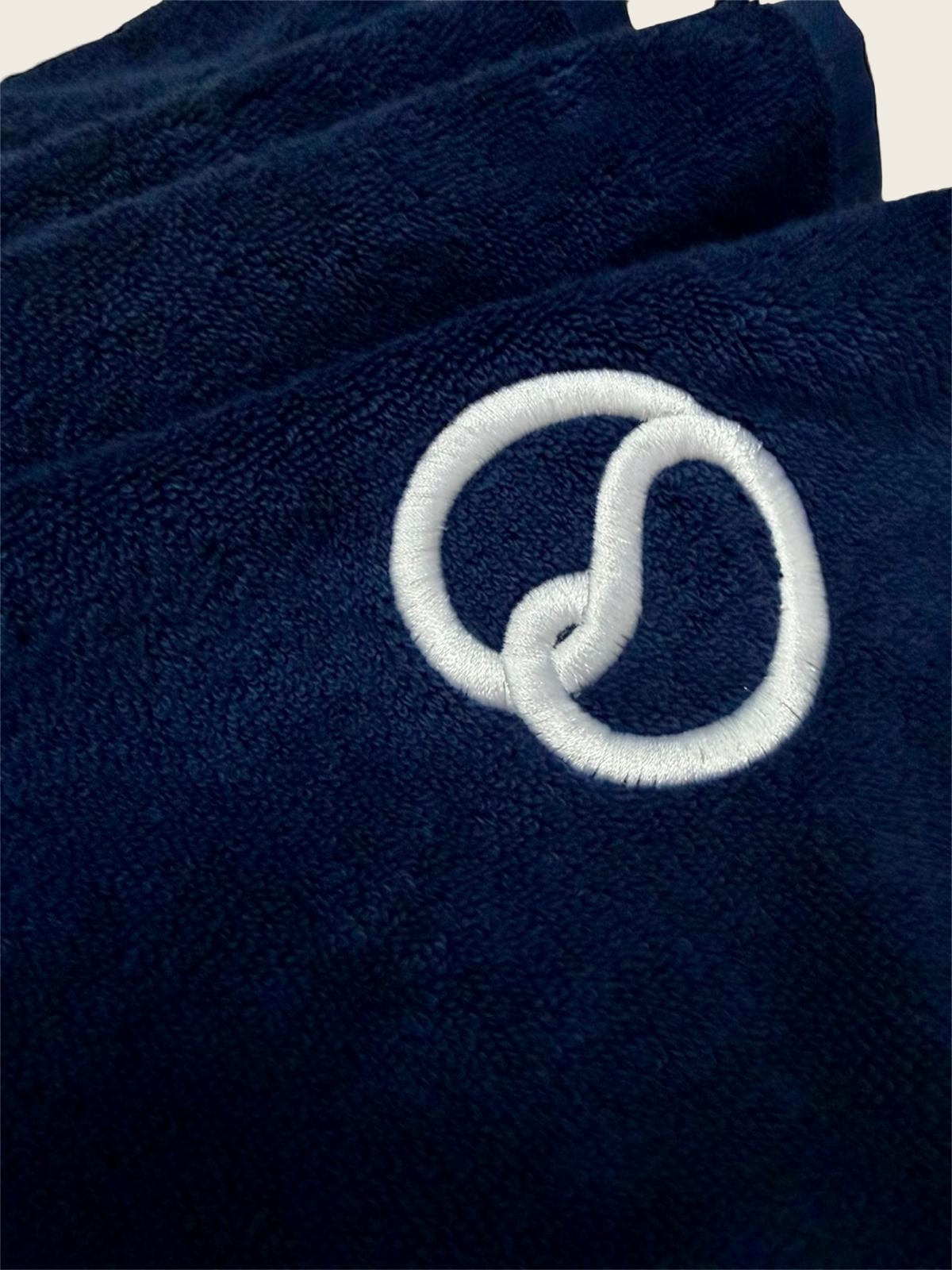 The embroidered MAASCH knot on the towel hem
